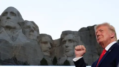 Reuters President Trump stands in front of Mount Rushmore