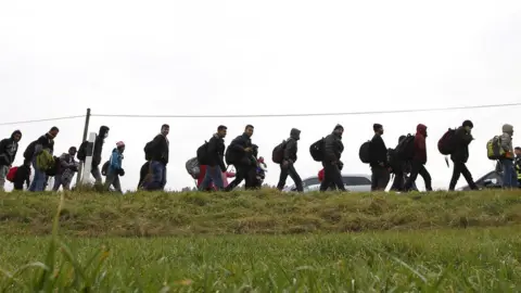 Reuters Migrants walking into Germany from Austria in 2015