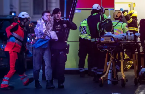 Profimedia/REX/Shutterstock Emergency service members help people hurt in a shooting at the Faculty of Arts has 14 victims, there will be a state mourning on Saturday, center, Prague, Czech republic - 21 Dec 2023