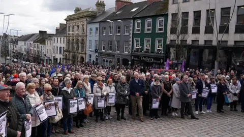 Brian Lawless/PA People gathered in Omagh
