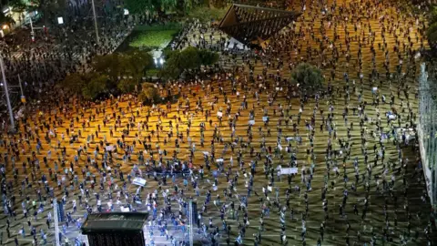AFP People take part in a protest against Benjamin Netanyahu in Tel Aviv on 19 April 2020