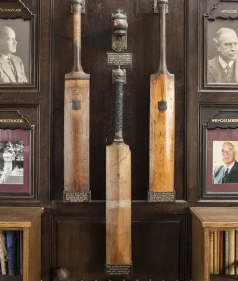 Historic England Cricket bats mounted in the principal room of Uppingham School's Cricket Pavilion