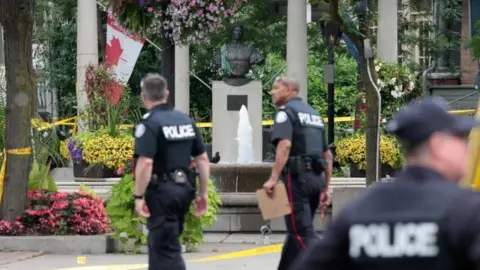 Reuters Police are seen near the scene of the shooting in Toronto, Canada, 23 July