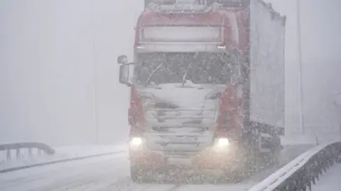 Getty Images a HGV drives through snow on the M62 motorway