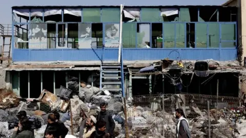 EPA Residents gathered at site of suicide car bomb attack in Kabul