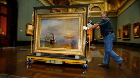 PA A National Gallery employee moving JMW Turner's 1839 work The Fighting Temeraire