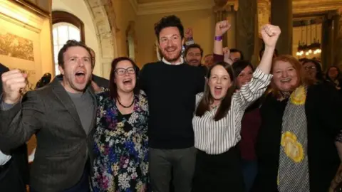 Pacemaker Alliance's Ross McMullan (centre) celebrates his election