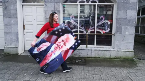 REUTERS/Clodagh Kilcoyne Woman carries Joe Biden poster