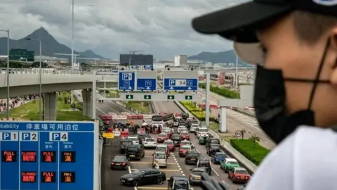 Getty Images A protester looks at a blocked road to Hong Kong's airport. Photo: 1 September 2109