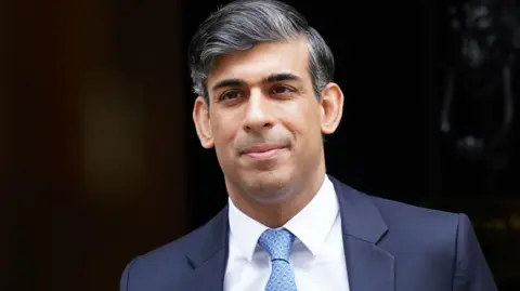 PA Media  Rishi Sunak wearing a suit and blue tie is seen leaving 10 Downing Street during his final days as prime minister