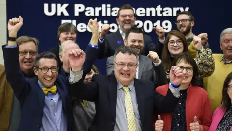 PA Media Stephen Farry celebrates his election with Alliance Party colleagues