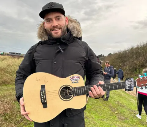 Nathan Adams Nathan Adams and his guitar signed by Ed Sheeran