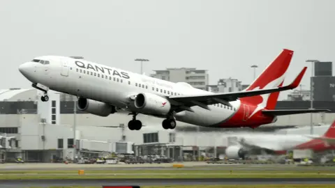 Getty Images A Qantas plane takes off from the Sydney International airport on May 6, 2021