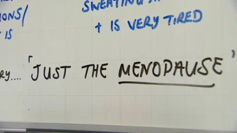 Whiteboard with 'just the menopause' written on it