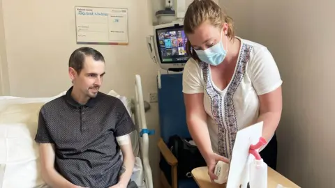 Worcestershire Acute Hospitals NHS Trust Daniel Waters receiving a demo from Emma Ludlow at The Insides Company