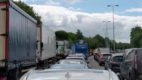 Mark Watson Cars in a queue