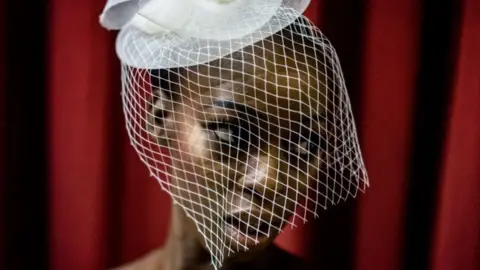 models waits backstage to enter the catwalk at the Africa Fashion Week in Lagos on June 3, 2017.