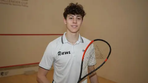 John Fairhall/BBC Jonah Bryant holding a racket