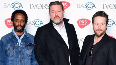 PA Media Pete Turner, Guy Garvey and Mark Potter of Elbow