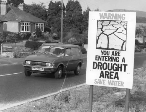 Getty Images A public information notice warning about the drought, erected by the road in the Bridport area of Dorset