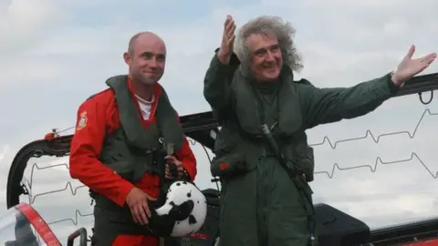 Flight Lieutenant Ben Plank with Queen guitarist Brian May