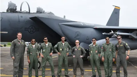 Getty Images The United States Air Force (USAF) and Indian Air Force (IAF) personnel are posing in front of a United States Air Force (USAF) F-15 Eagle fighter jet during the joint 'Exercise Cope India 2023' at the air force station in Kalaikunda, around 170 km west of Kolkata, on April 24th, 2023. T