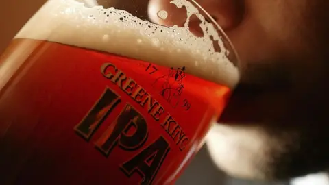 Getty Images Man drinks pint of beer