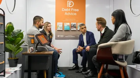 City Hall Sadiq Khan and Debt Free Advice inside bus