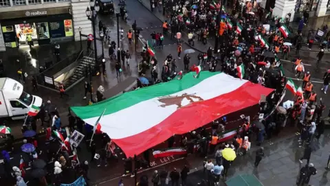 PA Media Demonstrators in Piccadilly Circus, London, protesting against the Islamic Republic of Iran after the death of Mahsa Amini (Jan 8, 2023)