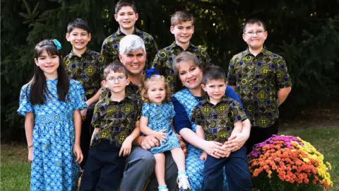 Believers Baptist Church Charles Wesco pictured with his wife and eight children