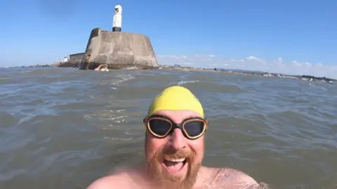 Tom Chapman Tom Chapman in the water in his swimming trunks