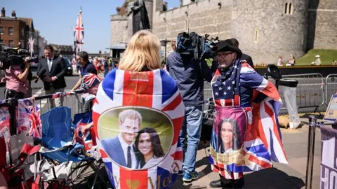 Getty Images Royal fans relax after setting up their positions outside Windsor Castle