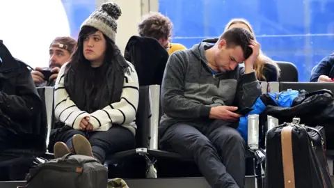 EPA  Passengers waiting for a flight at Gatwick airport in Sussex