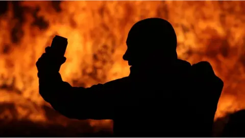 PA Media The huge bonfire in Craigyhill, Larne, is lit on the "Eleventh night" to usher in the Twelfth commemorations.