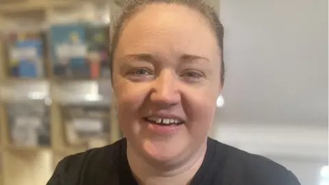 Mousumi Bakshi/BBC Woman with short dark hair and black top