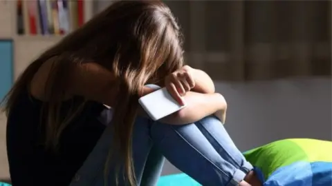 Getty Images Girl with head in hands
