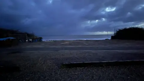 Andrew Turner/BBC A gap in the cliffs has exposed a sea view at Hemsby beach car park.