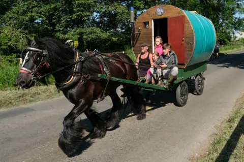 Getty Images A traditional bow top caravan is driven to the campsite on the first day of the Appleby Horse Fair