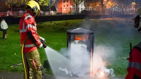 GMFRS firefighter extinguished fire by bin
