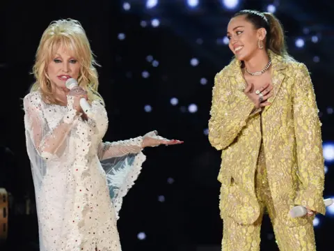 Getty Images Dolly Parton and Miley Cyrus