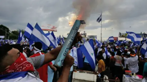 Getty Images Anti-government demonstrator fires a home-made mortar during a protest in Managua on May 26, 2018