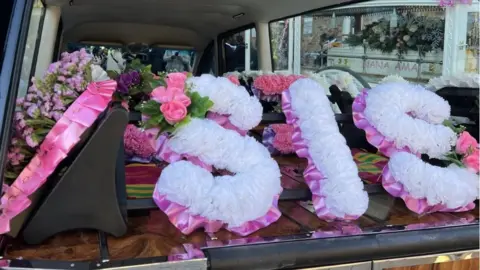 Wendy Hurrell/BBC Floral tribute reading "Sis"