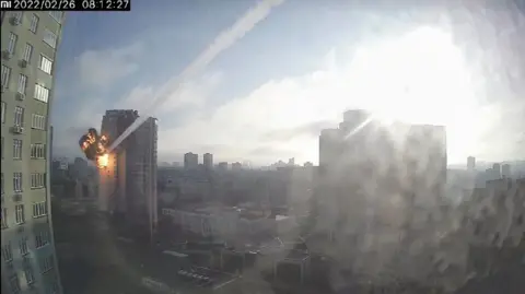 Reuters Surveillance footage shows a missile hitting a residential building in Kyiv, Ukraine, February 26, 2022, in this still image taken from a video obtained by REUTERS.