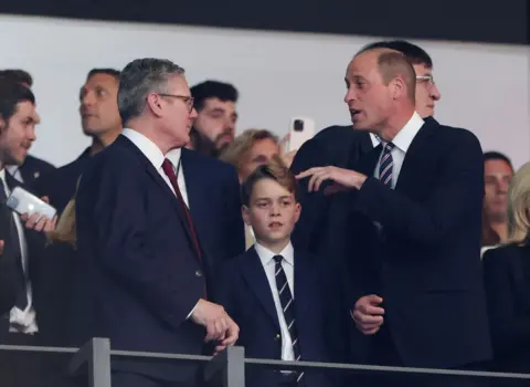 Getty Images Sir Keir Starmer, PM, and Prince William engage in conversation across Prince George who is looking down at the pitch in Berlin - before kick-off in the Euro 2024 final