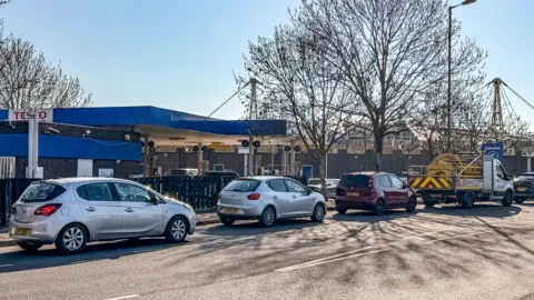 Ben Birchall/PA Wire Drivers queuing in their vehicles for petrol at Tesco in Eastville, Bristol.