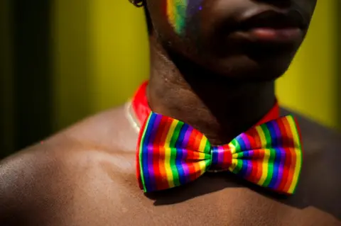 Eduardo Munoz / Reuters A man wears a rainbow bow tie