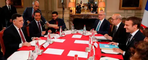 AFP French President Emmanuel Macron (R) and Libyan Prime Minister Fayez al-Sarraj (L) attend a meeting for talks aimed at easing tensions in Libya