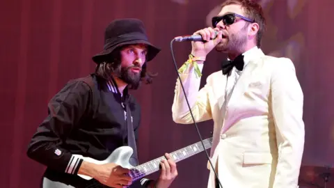 Getty Images Serge started the band with Tom Meighan in the late 1990s and they went on to headline Glastonbury Festival in 2014