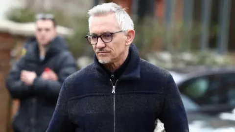 Reuters Gary Lineker walking outside his home with members of the press behind him