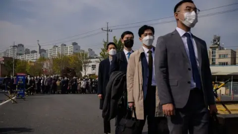 Getty Images South Korean Jehovah's Witnesses and conscientious objectors to mandatory military service line up to enter a correctional facility to begin training as administrators, in Daejeon on October 26, 2020